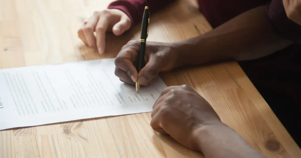 man signing lease