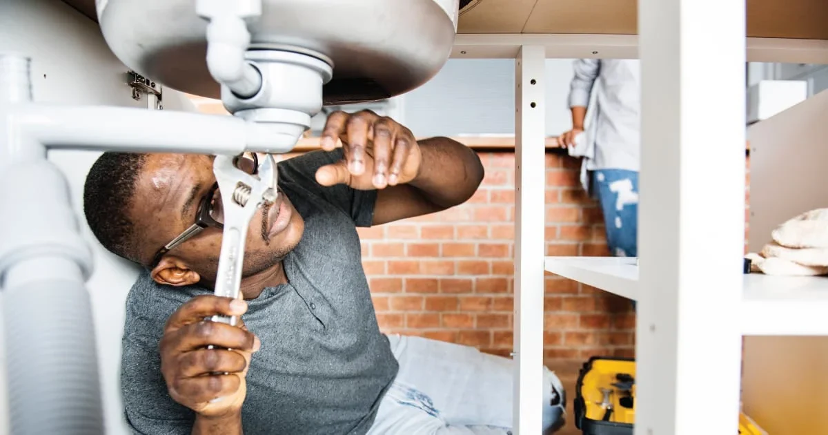 man fixing broken sink
